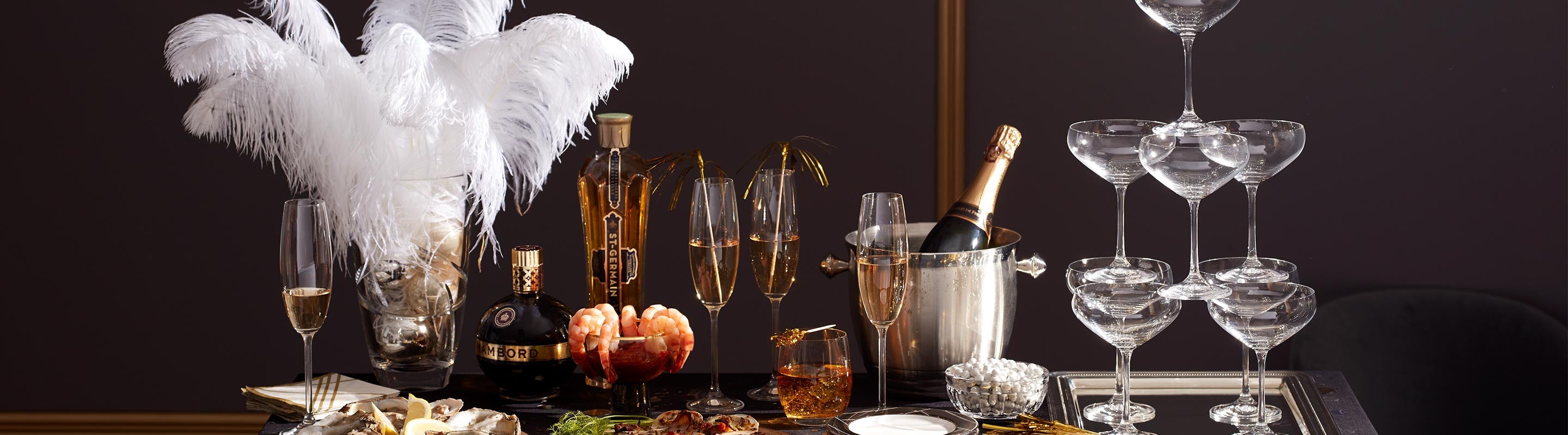 Silver ice bucket next to a champagne coupe tower