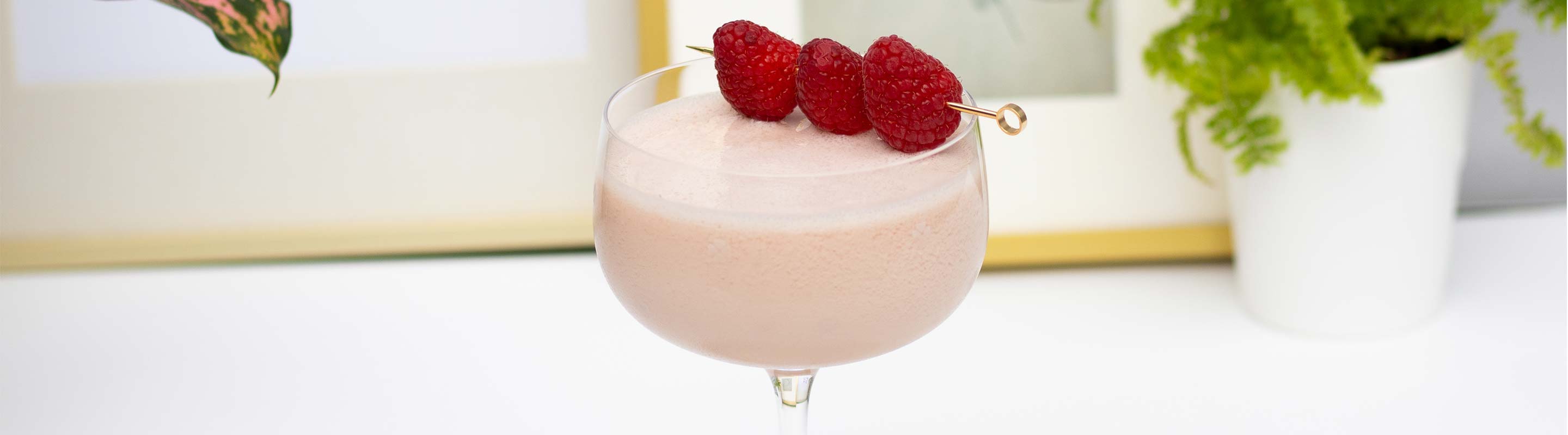 Berry Cocktail in Coupe Glass with raspberries
