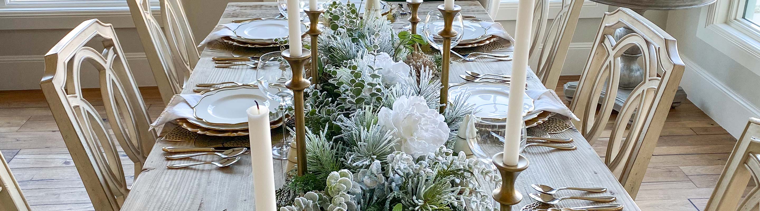 A dinner table with silver and gold dishes