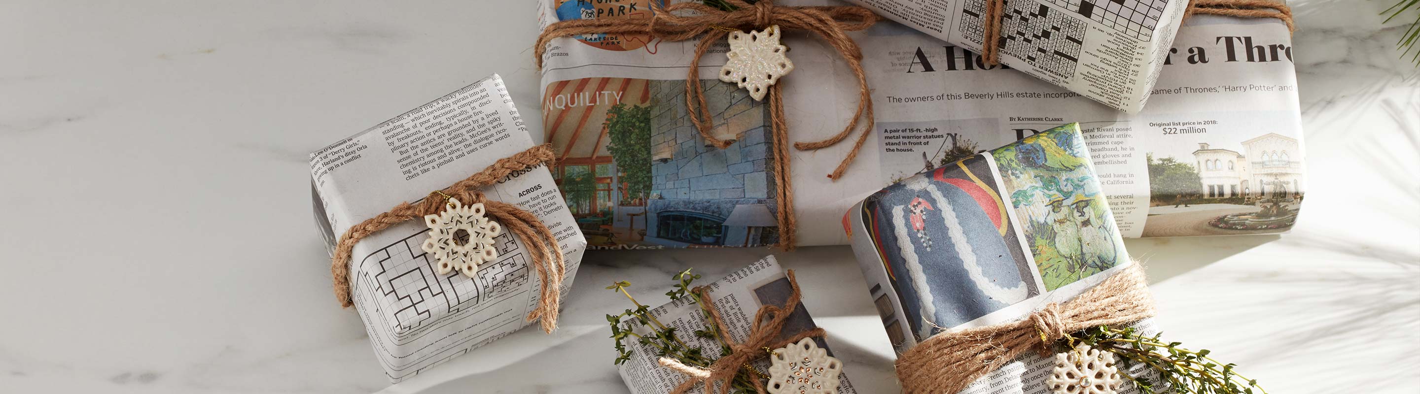 Christmas present wrapped in newspaper and decorated with Lenox Ornaments