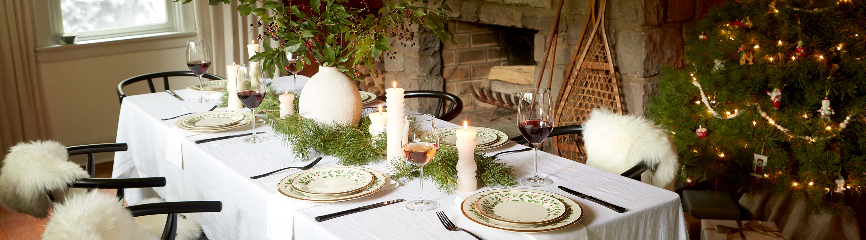 Rustic Christmas dinner table set with Holiday Dinnerware and candles