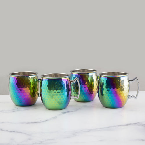 Four iridescent mugs on a marble surface with a white background