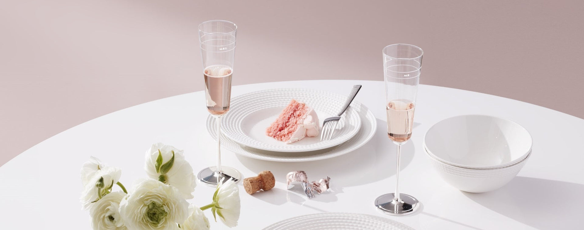 Celebratory table setting with cake and champagne