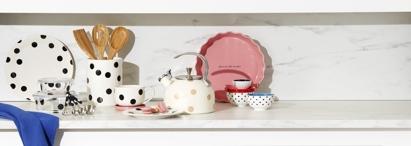 Polka dot themed kitchenware and utensils on a marble counter