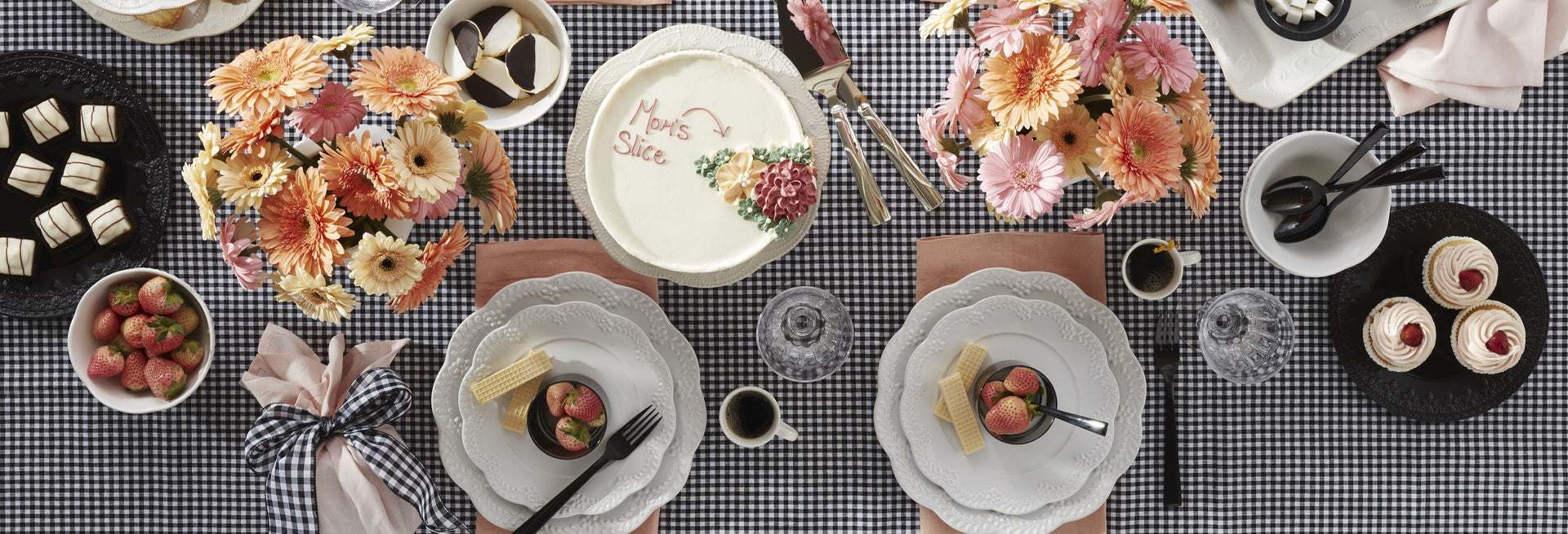 A festive table setting with cake and flowers