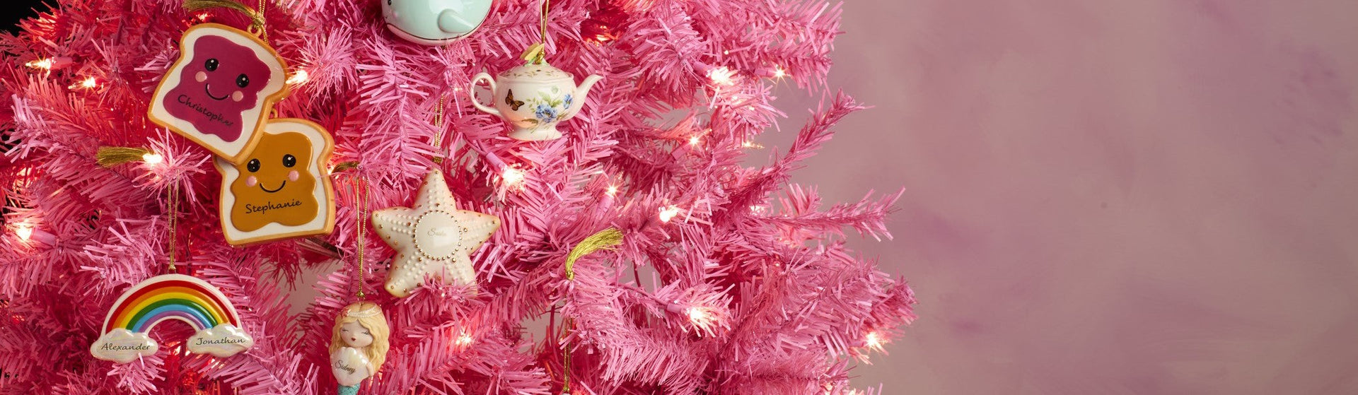 Pink tree with personalized Christmas ornaments.