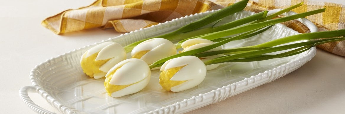 Deviled egg "tulips" on a white tray.