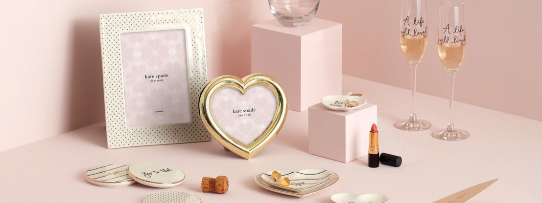 Collection of pink and gold Kate Spade home accessories.