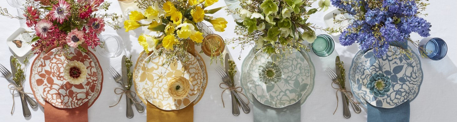 table with orange, yellow, green, and blue place settings