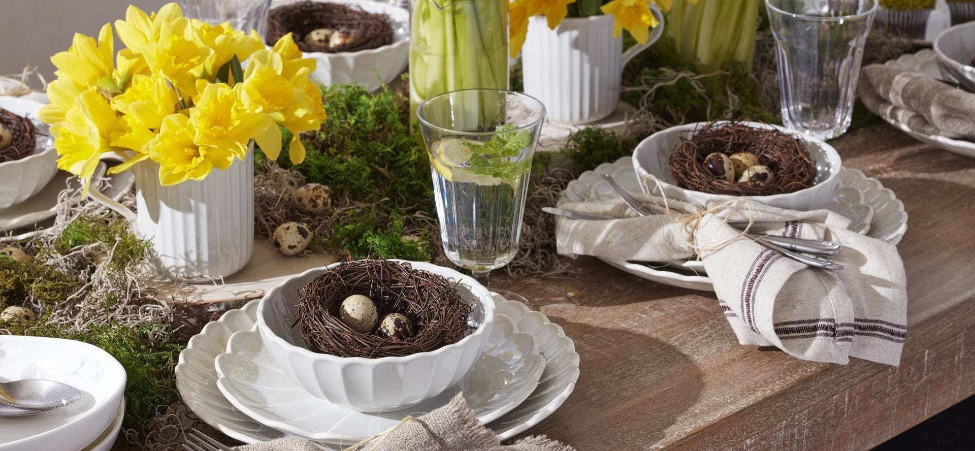 Spring table setting with daffodils and nests