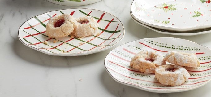 Jam-filled cookies on festive holiday plates