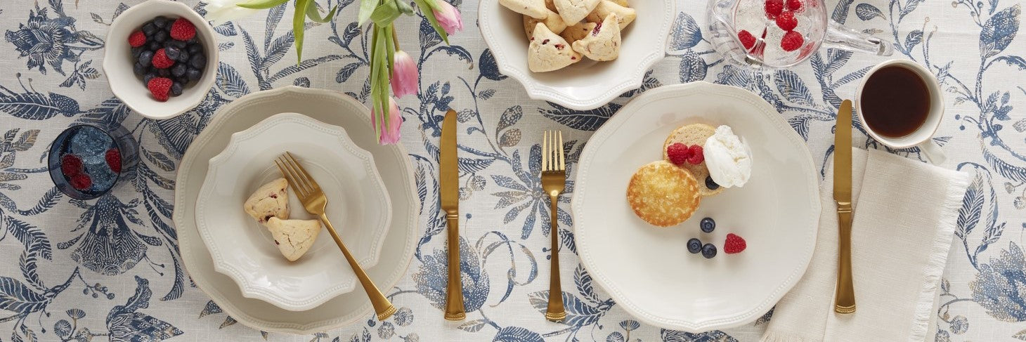 white plates on a blue floral tablecloth