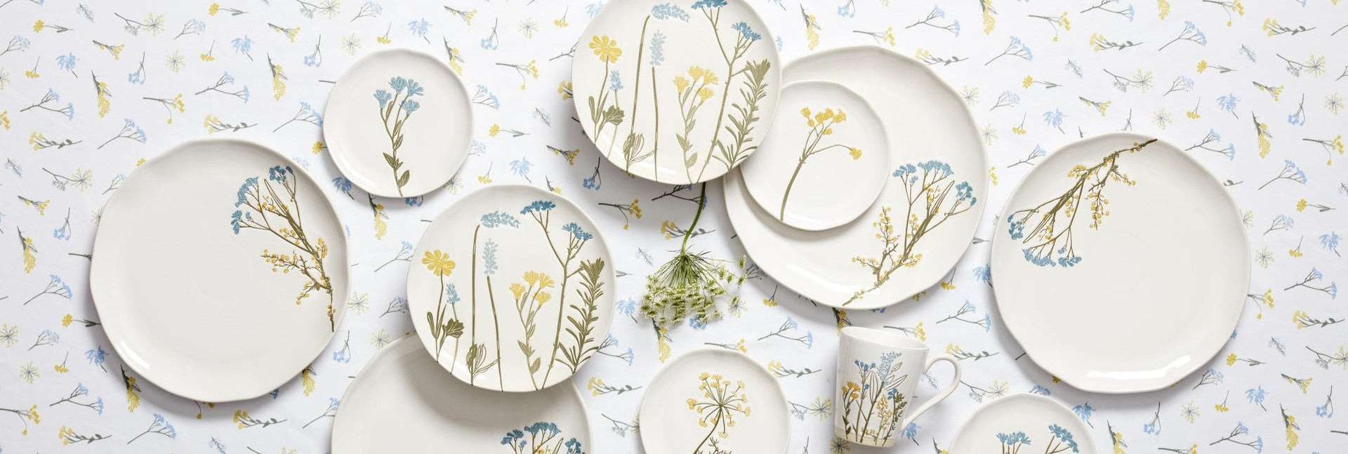 Cream ceramic dinnerware with blue and yellow wildflowers