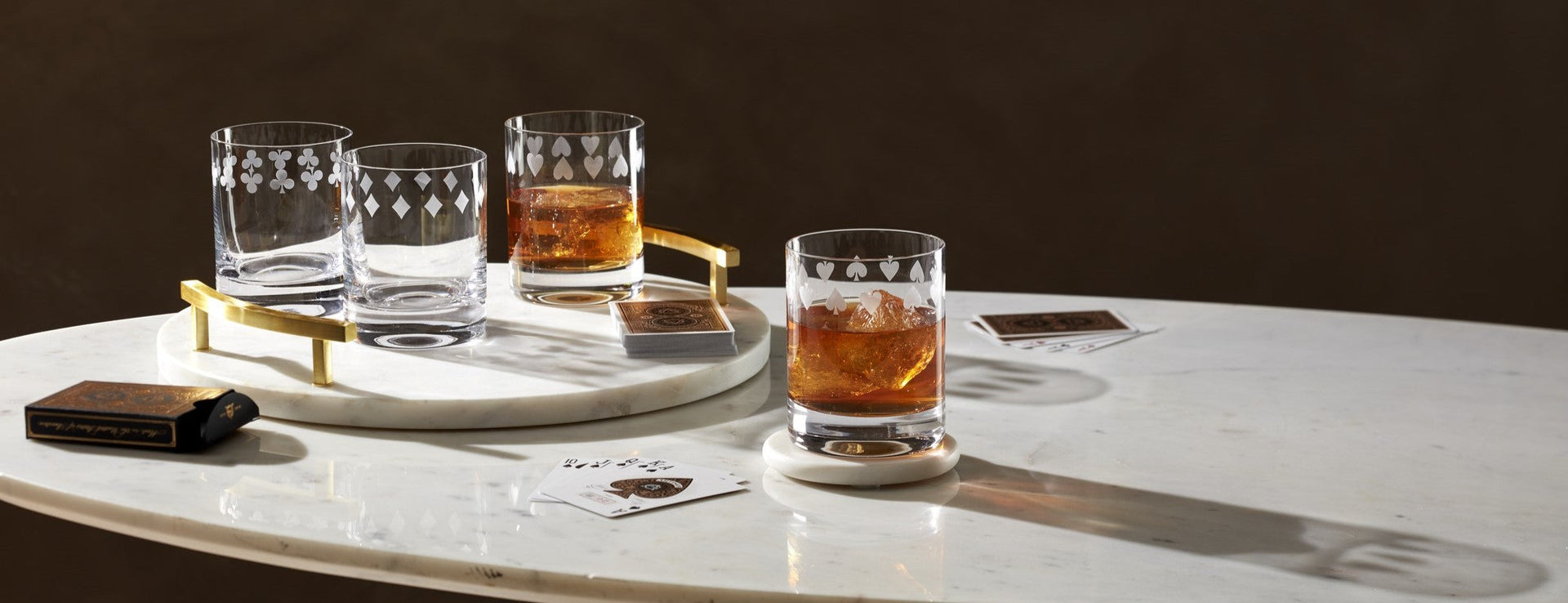 Etched playing card glassware on marble
