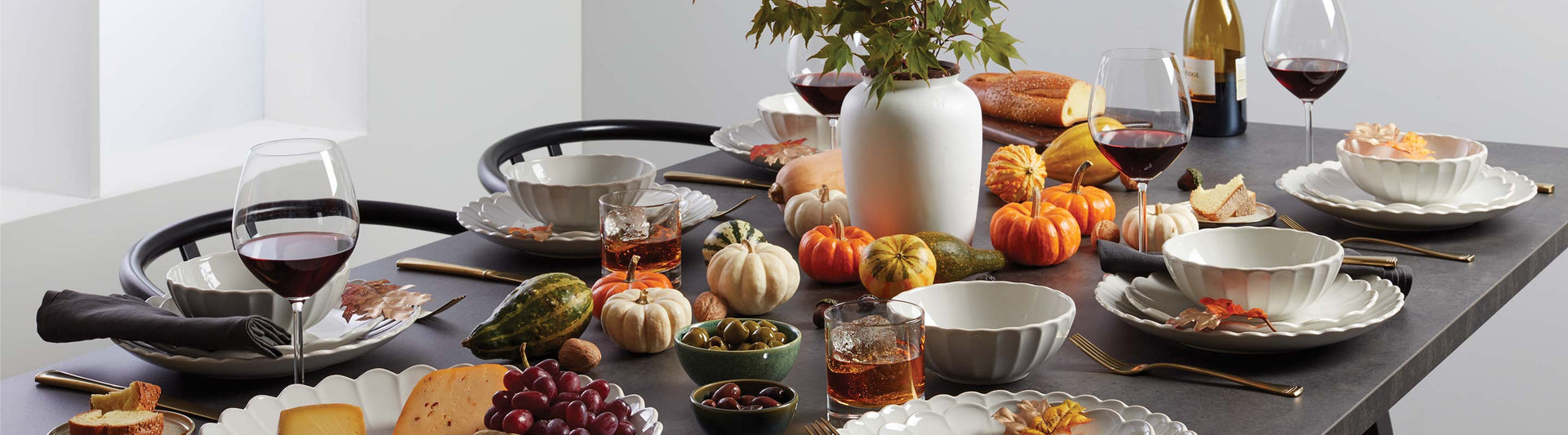 Thanksgiving table with French Perle Scallop dishes and mini orange pumpkins