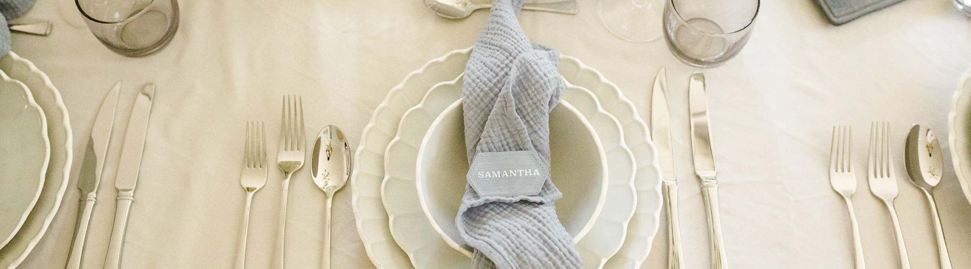 Lenox French Perle Scallop White Dinnerware placesetting on white linen tablecloth with silver flatware