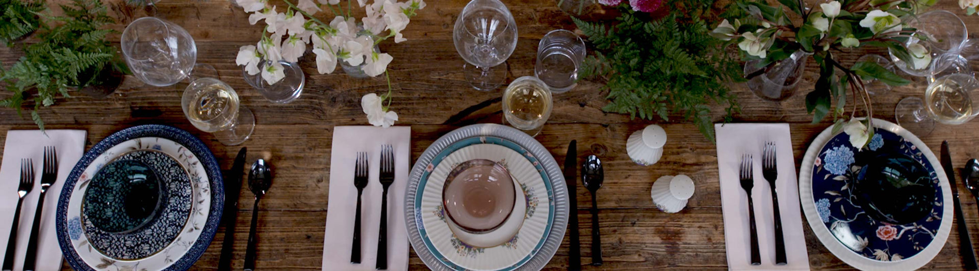 A table setting with mix and match Lenox dishes and flowers