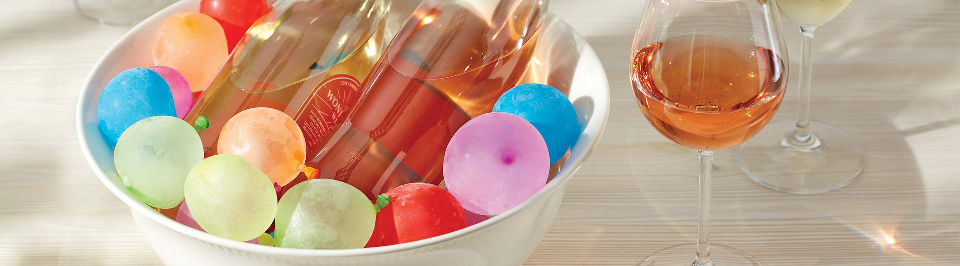 Serving bowl with wine bottles and ice balloons