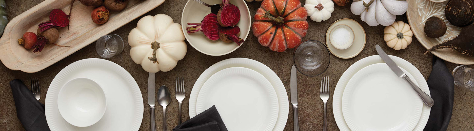 Tablescape with white dishes and pumpkins