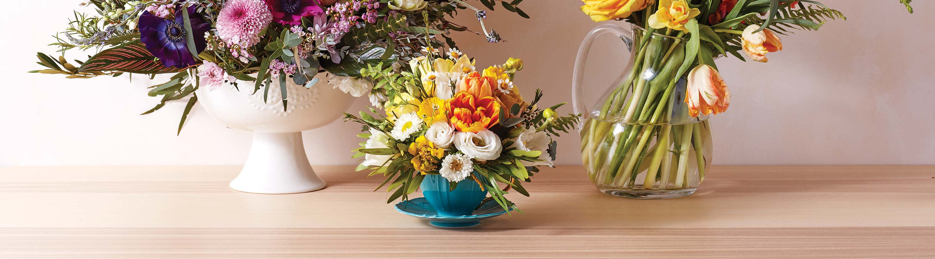 Flowers in a teacup and pitcher