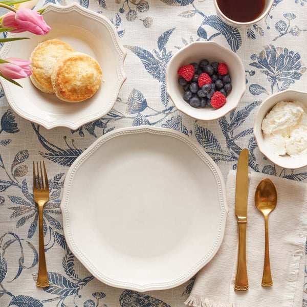 Tablescape with French Perle Bead dinnerware and gold flatware.