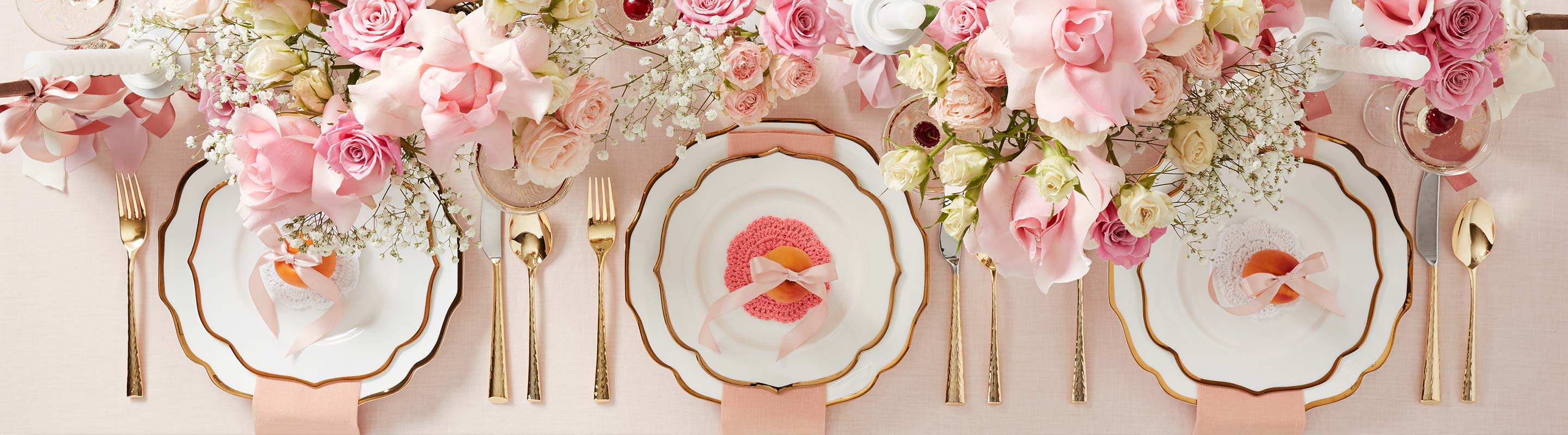 Dinner table with valentine’s day themed decor and flowers