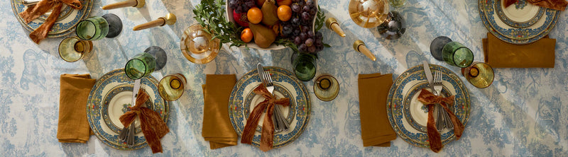Thanksgiving dinnerware and decor laid out on a table